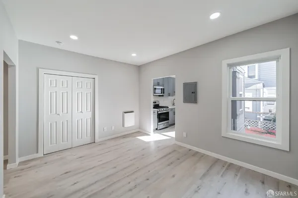a view of a kitchen with furniture and wooden floor