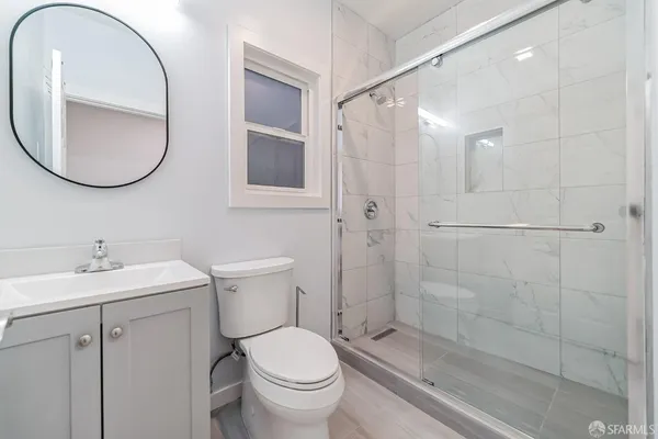 a bathroom with a toilet sink and a mirror