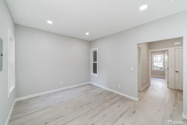 a view of hallway with wooden floor