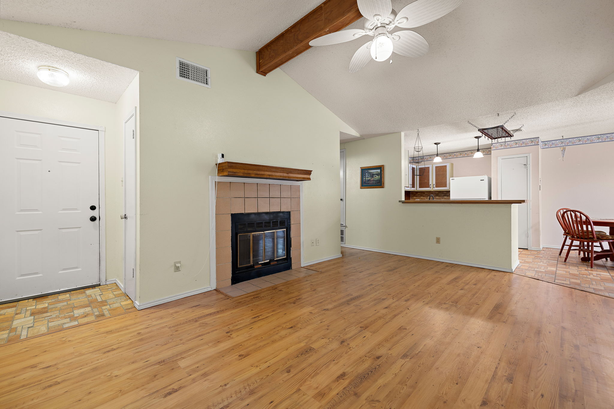 11709 Rotherham Drive Austin, TX 78753 - Photo 1 of 25 A welcoming entryway transitions into a spacious living area, highlighted by a cozy fireplace and vaulted ceilings.