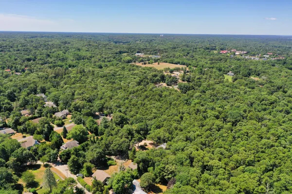 an aerial view of a houses with a yard and lake view