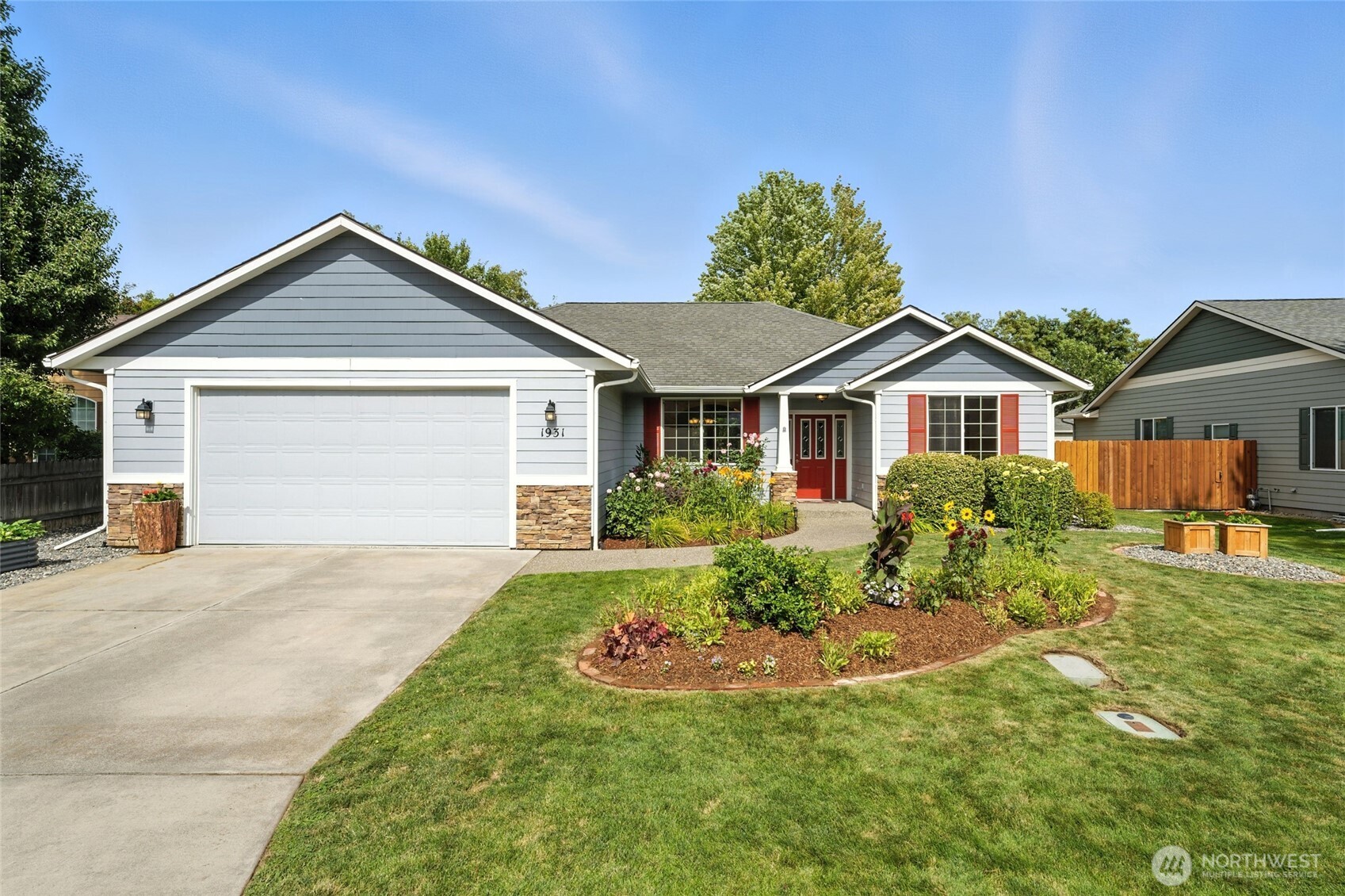 1931 Gemstone Drive Walla Walla, WA 99362 - Photo 2 of 40 a front view of a house with a yard and garage