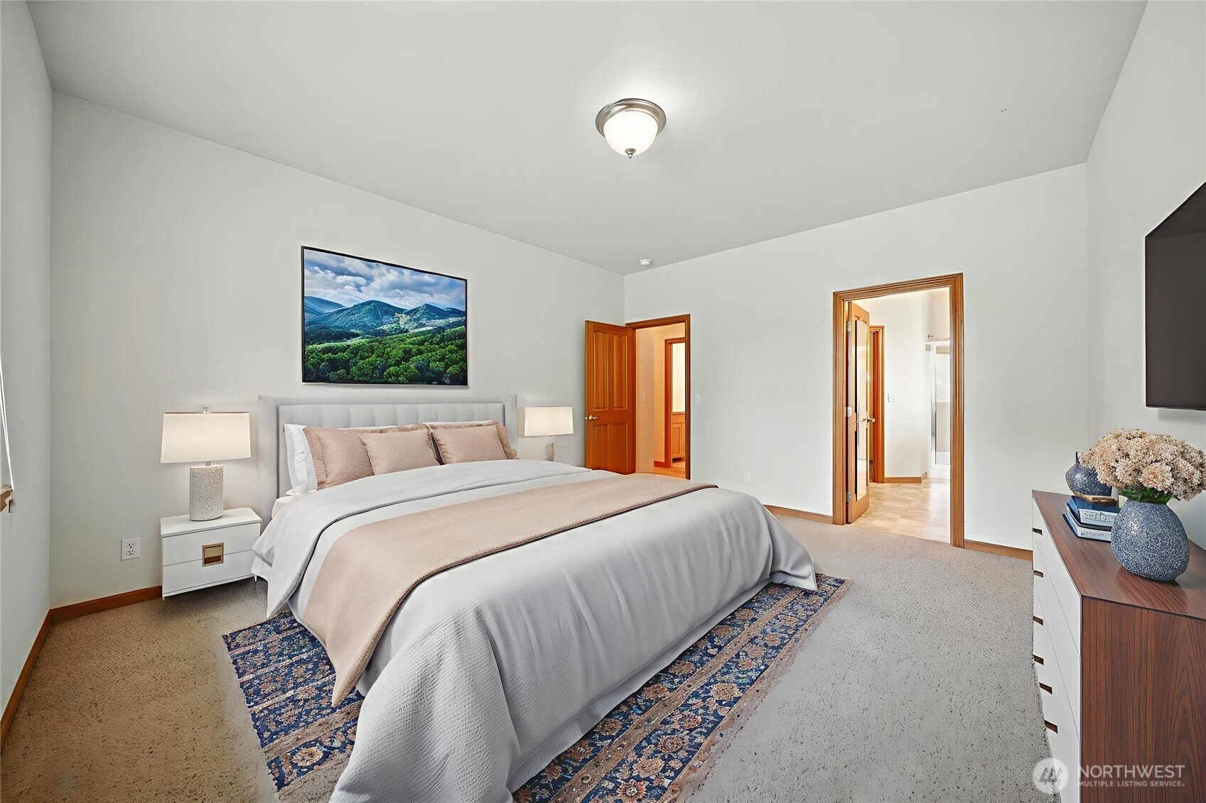 1931 Gemstone Drive Walla Walla, WA 99362 - Photo 23 of 40 a spacious bedroom with a bed and a painting on the wall