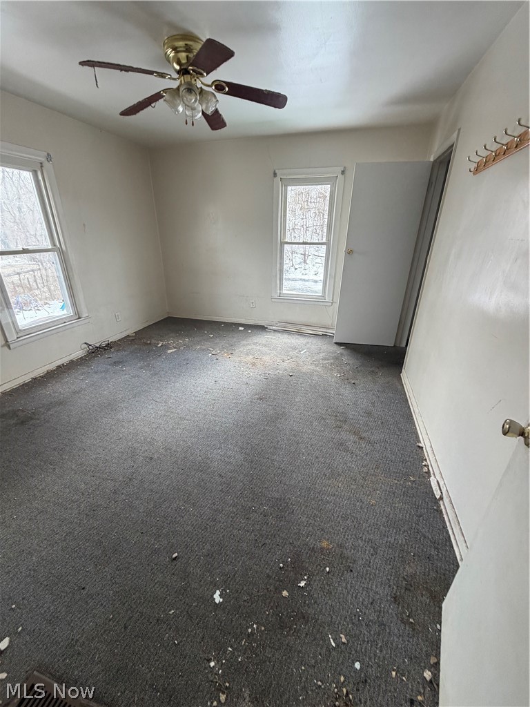 55060 National Road Bridgeport, OH 43912 - Photo 10 of 14 Carpeted empty room featuring baseboards and ceiling fan