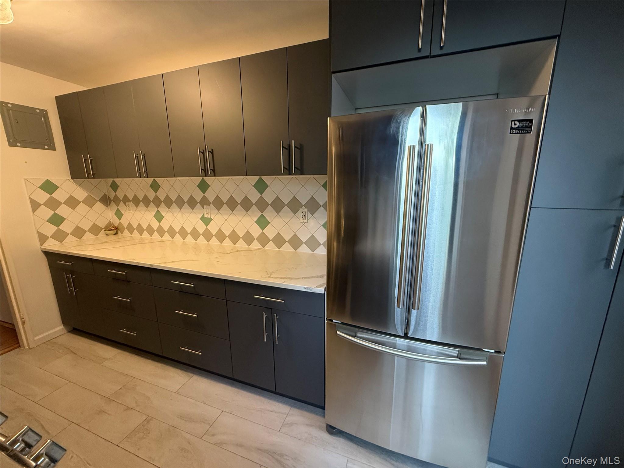 65-15 38th Avenue, Unit 5P Queens, NY 11377 - Photo 13 of 15 a kitchen with a refrigerator and a sink