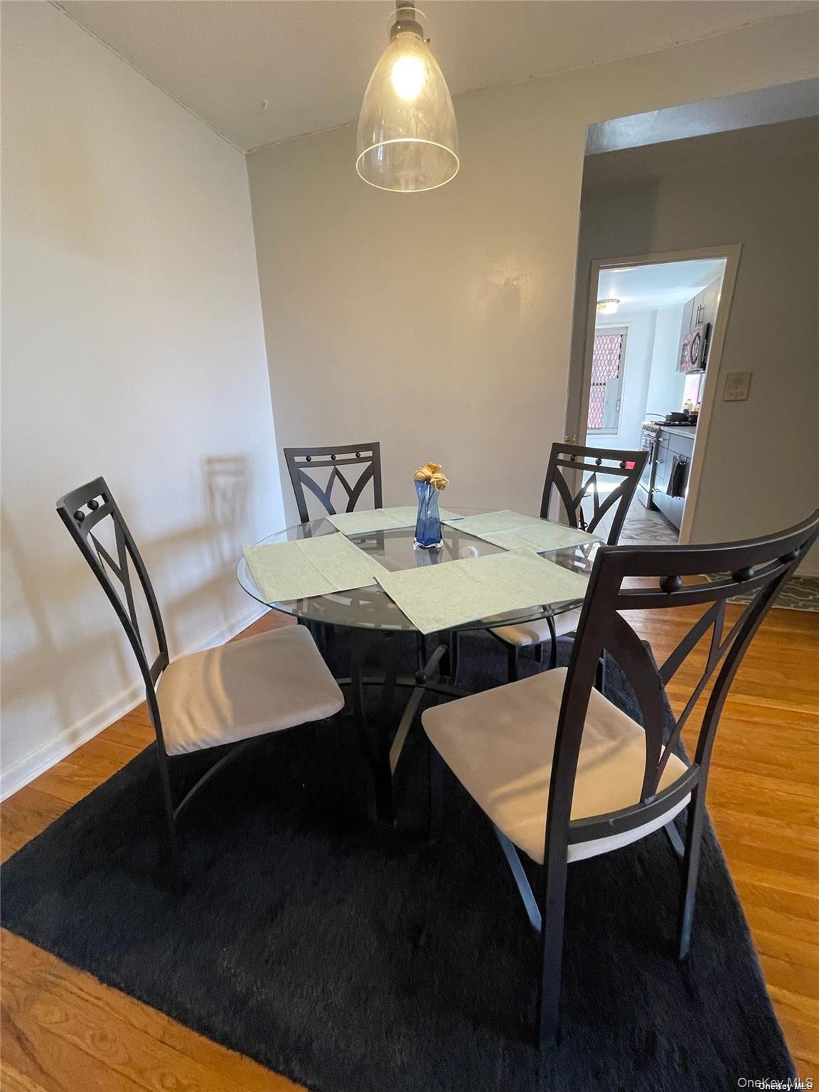 65-15 38th Avenue, Unit 5P Queens, NY 11377 - Photo 6 of 15 a view of a dining room with furniture and wooden floor