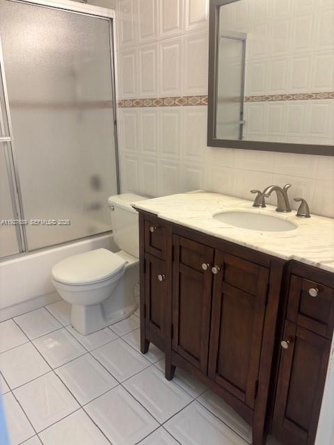9002 Southwest 137th Street, Unit G27 Miami, FL 33176 - Photo 8 of 11 a bathroom with a granite countertop toilet a sink and a mirror