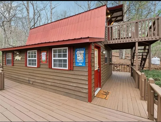 a view of a house with wooden deck