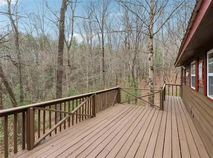 a view of balcony with wooden floor and fence