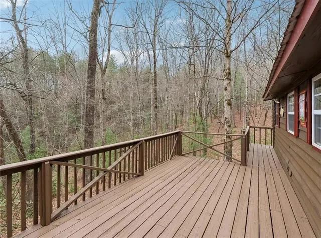 a view of balcony with wooden floor and fence
