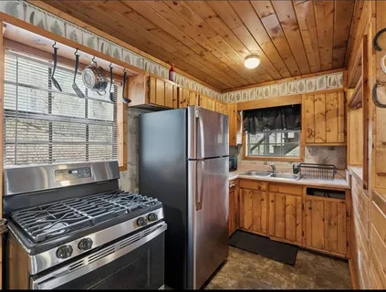 a kitchen with a stove a refrigerator and a sink