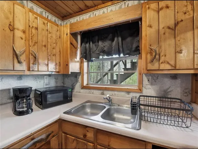 a kitchen with a sink and a stove top oven