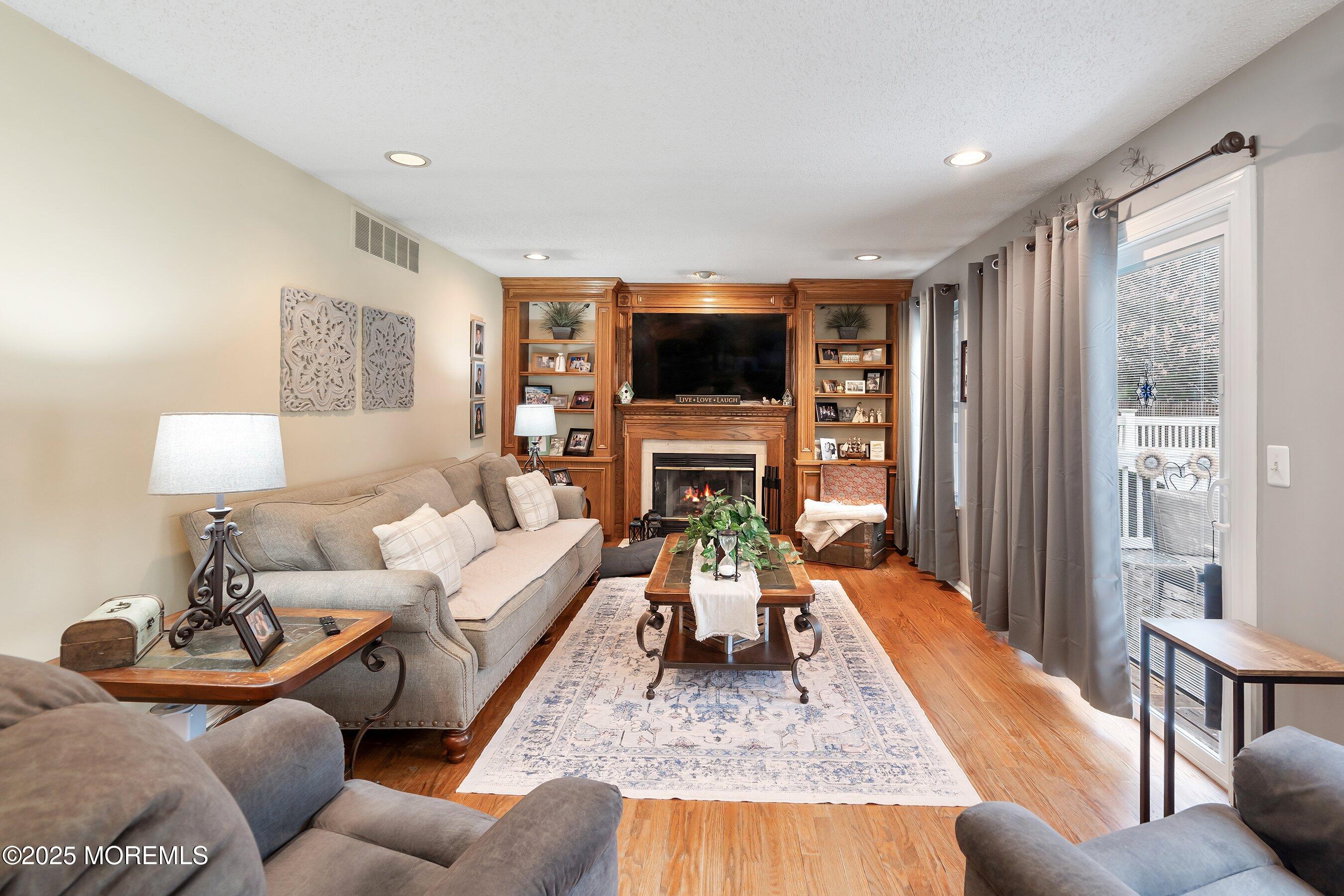 47 Crater Lake Road Howell, NJ 07731 - Photo 13 of 40 a living room with furniture fireplace and a flat screen tv