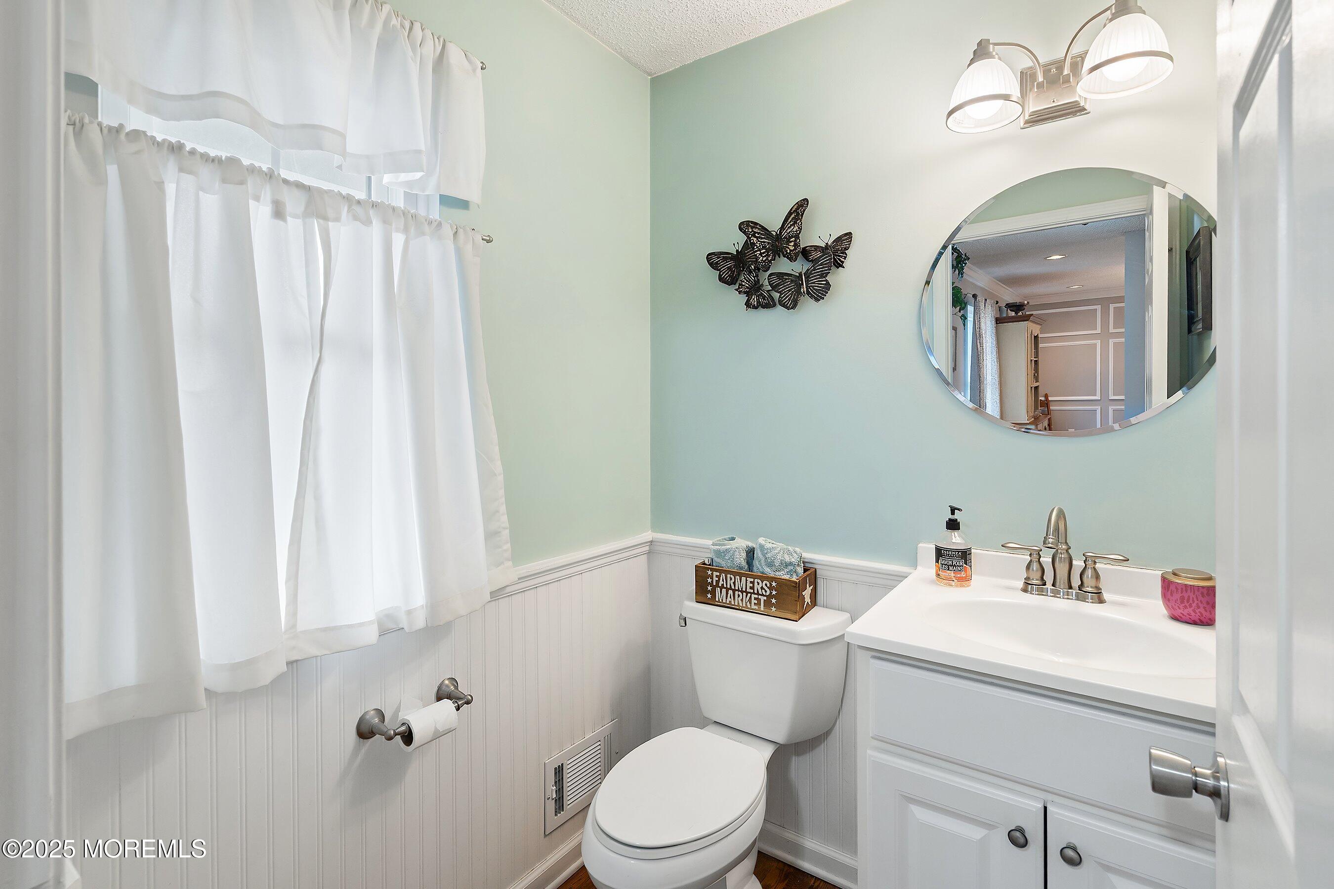 47 Crater Lake Road Howell, NJ 07731 - Photo 14 of 40 a bathroom with a toilet sink and mirror