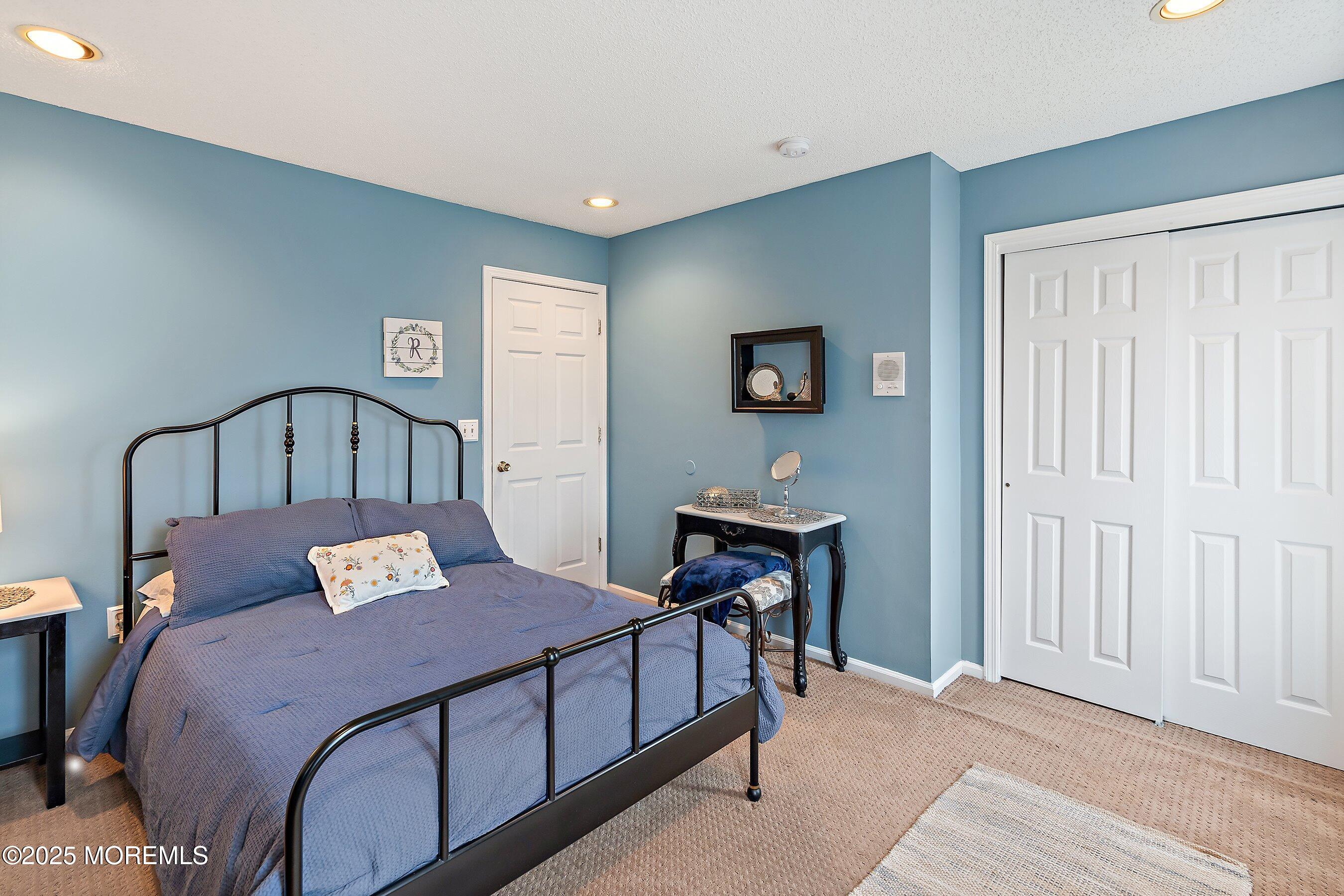 47 Crater Lake Road Howell, NJ 07731 - Photo 16 of 40 a bedroom with a bed and a table in it