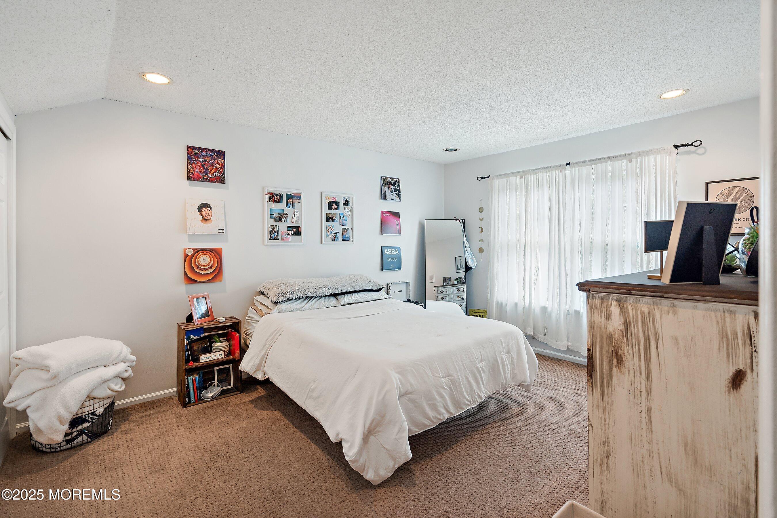 47 Crater Lake Road Howell, NJ 07731 - Photo 19 of 40 a bedroom with a bed and a refrigerator