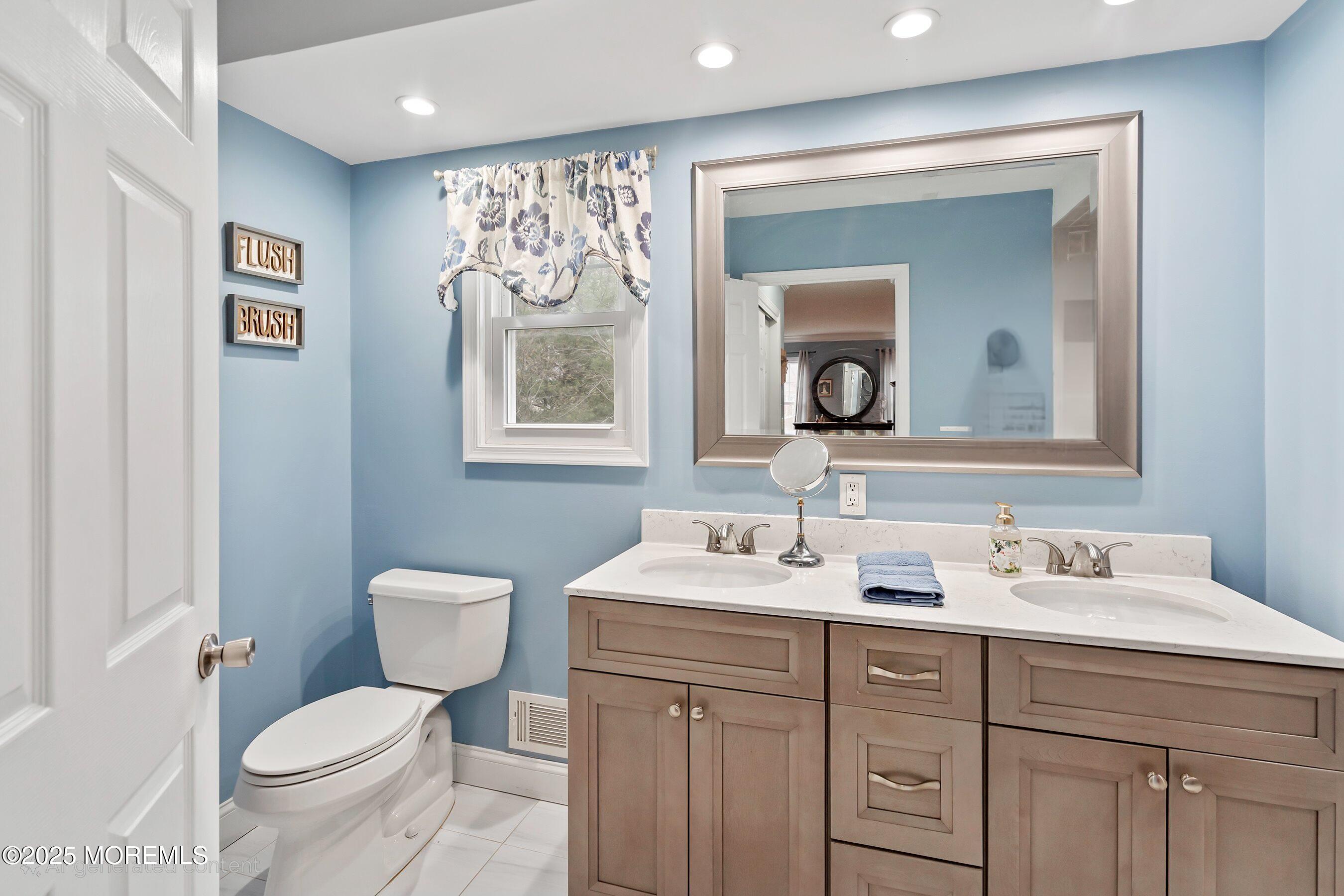 47 Crater Lake Road Howell, NJ 07731 - Photo 25 of 40 a bathroom with a toilet sink and mirror