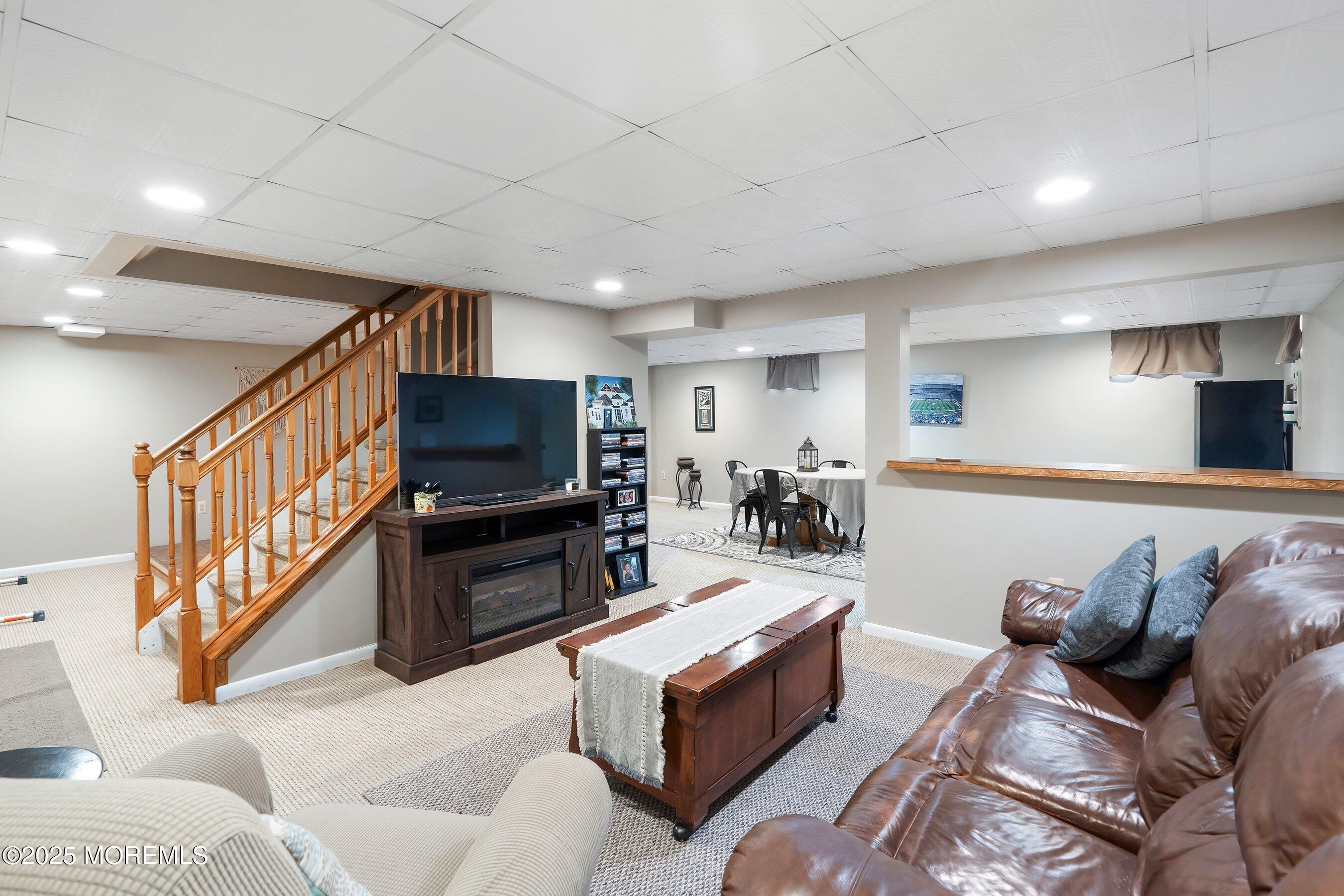 47 Crater Lake Road Howell, NJ 07731 - Photo 28 of 40 a living room with furniture and a flat screen tv