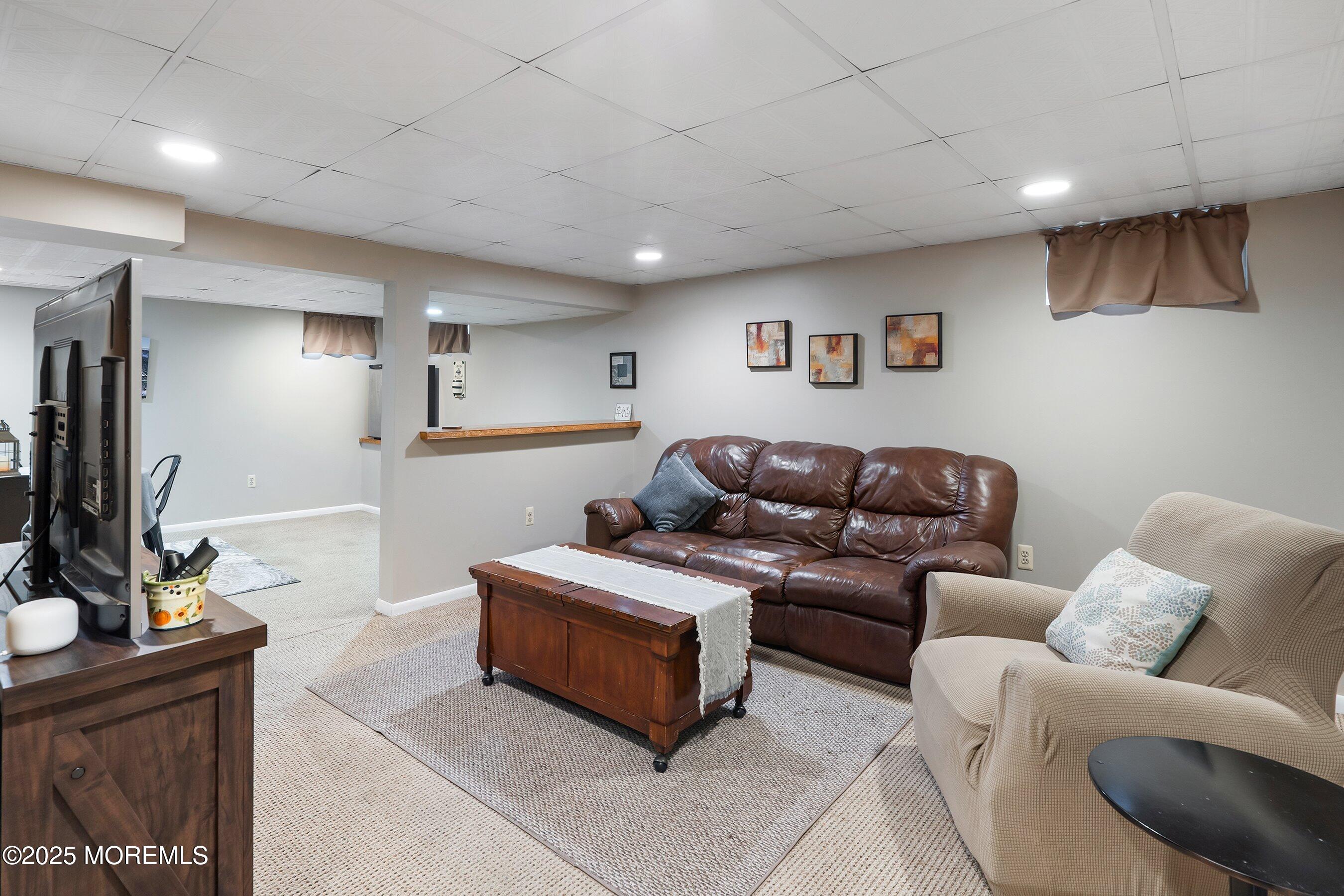 47 Crater Lake Road Howell, NJ 07731 - Photo 29 of 40 a living room with furniture and a flat screen tv
