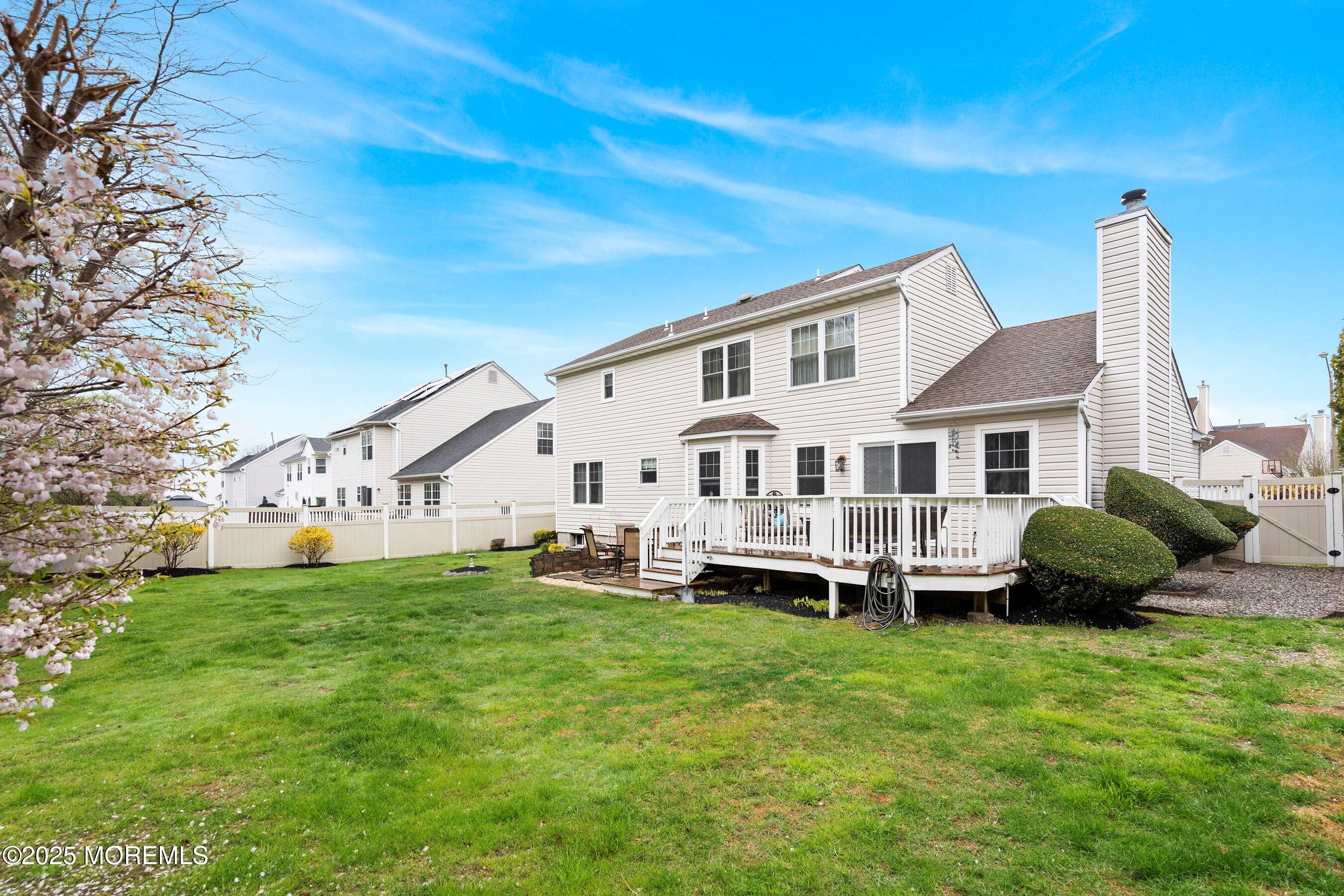 47 Crater Lake Road Howell, NJ 07731 - Photo 34 of 40 a front view of a house with a garden and deck