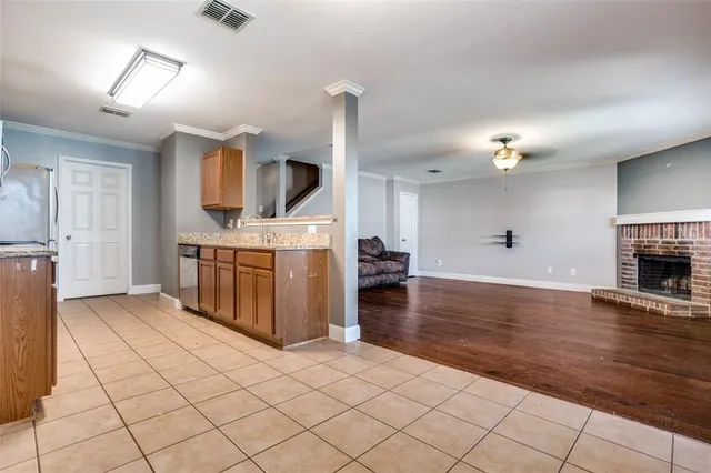 a kitchen with kitchen island sink stove and cabinets
