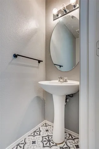a bathroom with a sink and mirror