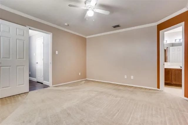 an empty room with fan and entrance