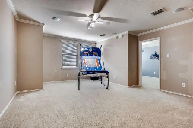 a living room with furniture and a ceiling fan