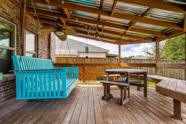 a view of a roof deck with a table and chairs