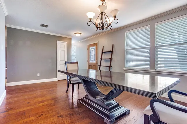 a living room with furniture pool table and windows