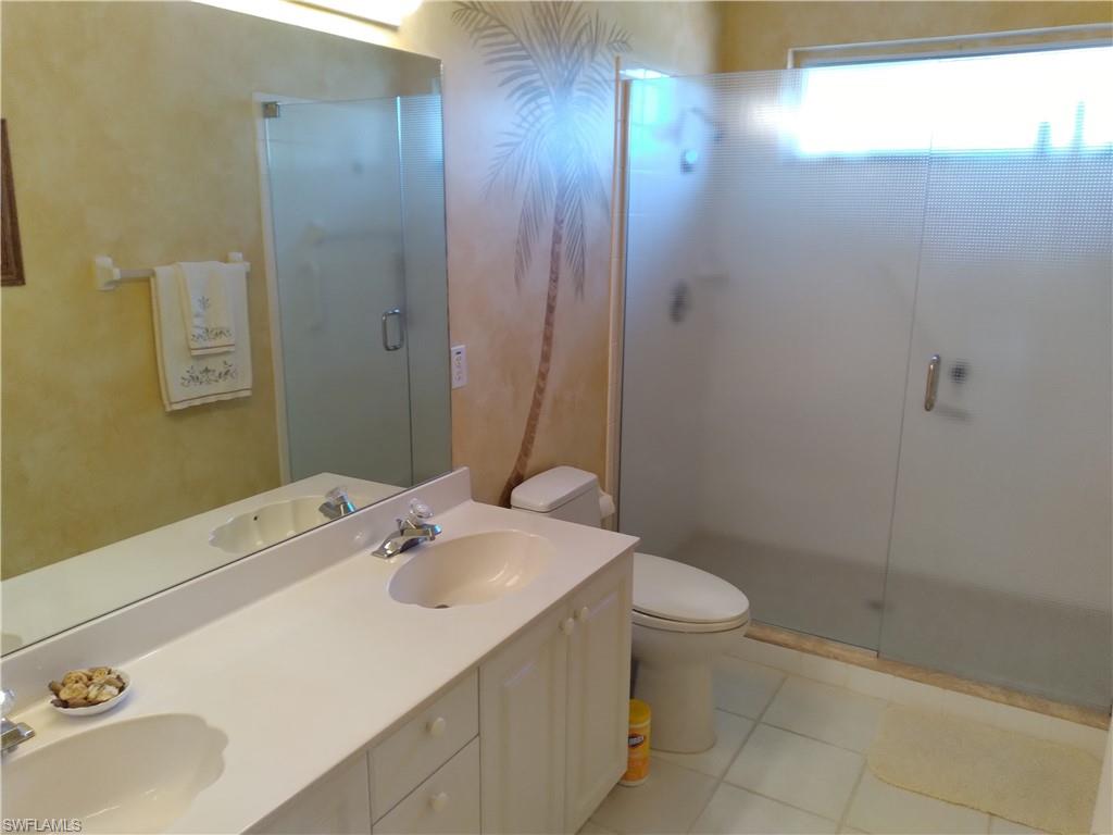 900 Diamond Circle, Unit 908 Naples, FL 34110 - Photo 12 of 22 a bathroom with a sink a toilet and shower
