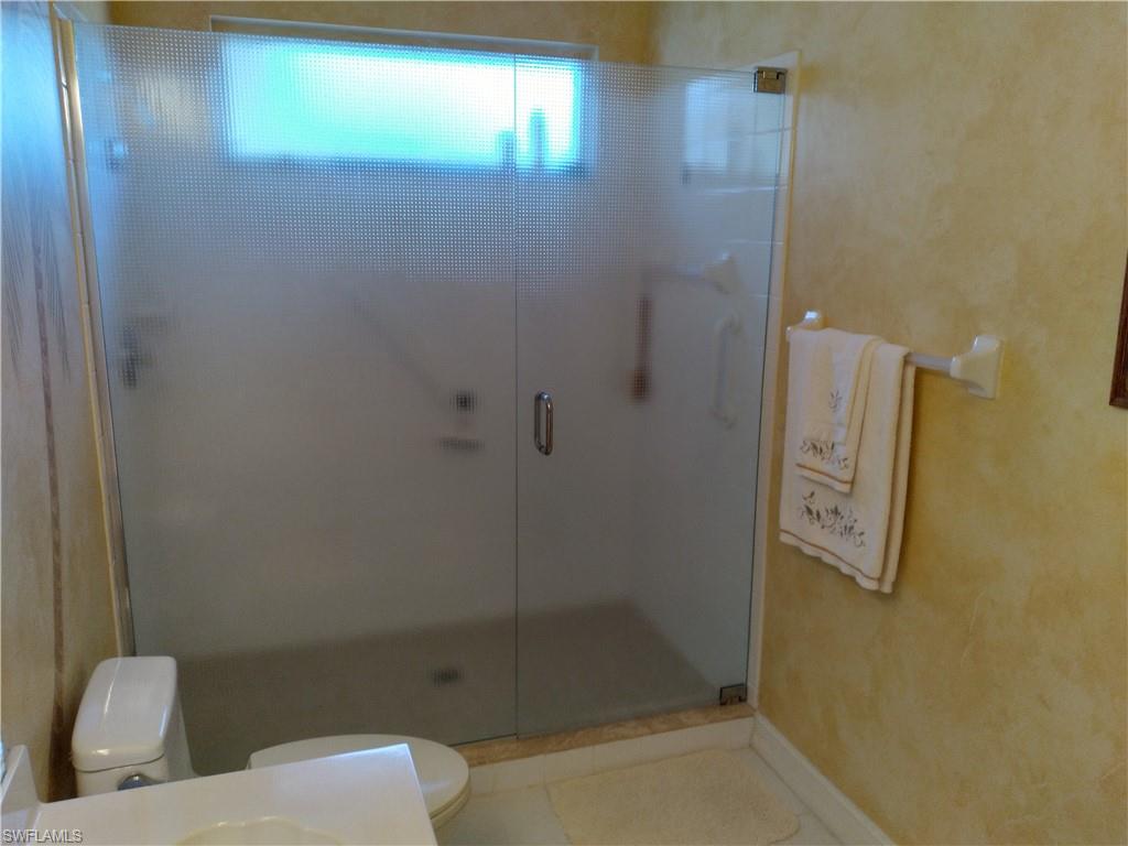 900 Diamond Circle, Unit 908 Naples, FL 34110 - Photo 14 of 22 a bathroom with a shower and toilet