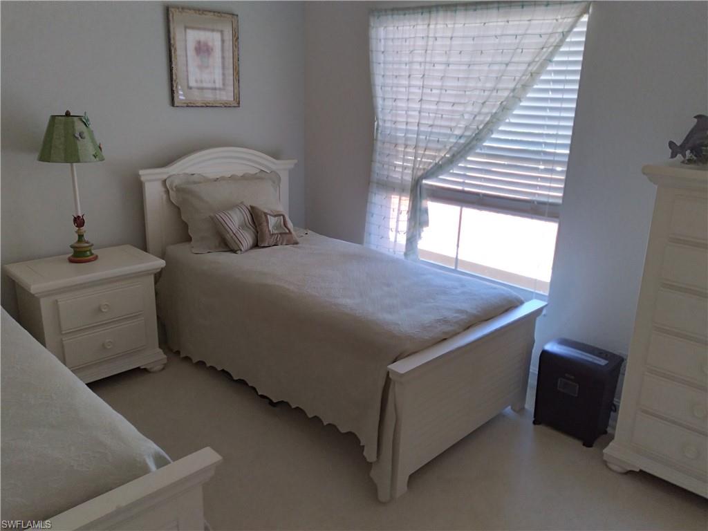 900 Diamond Circle, Unit 908 Naples, FL 34110 - Photo 16 of 22 a bedroom with a bed and a window