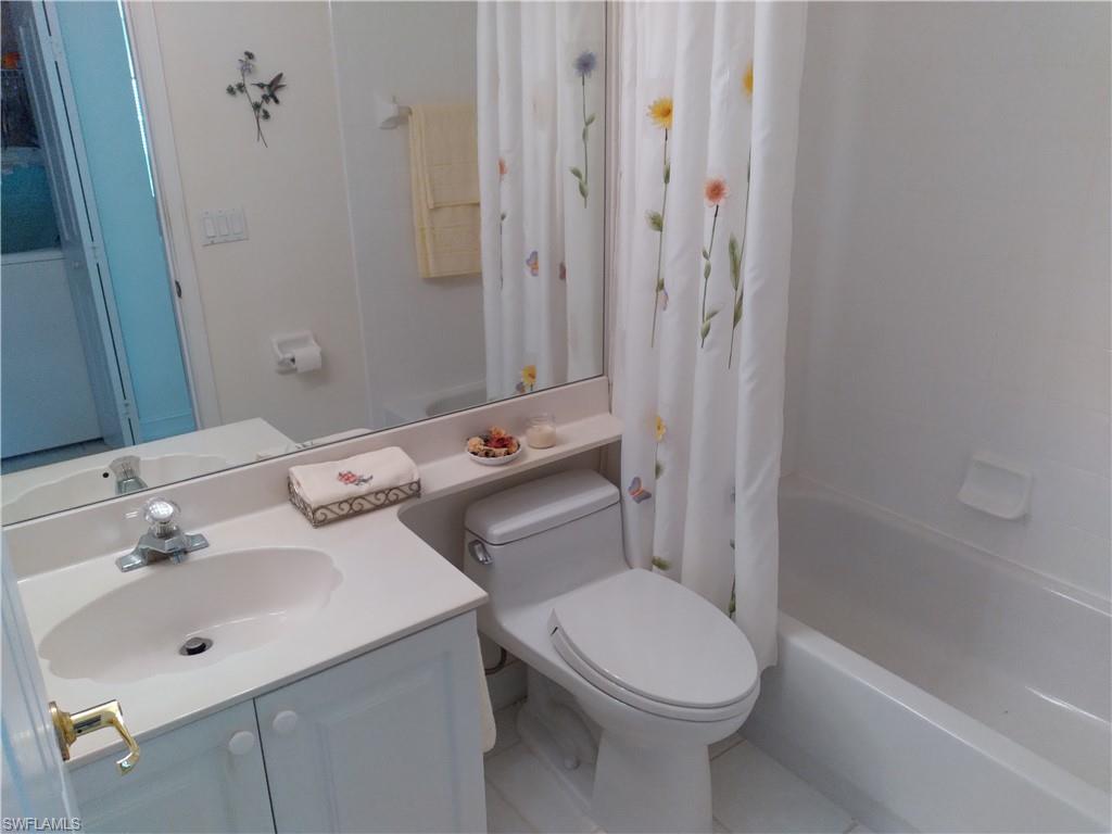 900 Diamond Circle, Unit 908 Naples, FL 34110 - Photo 17 of 22 a bathroom with a sink toilet and shower