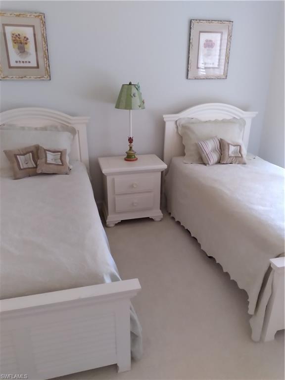 900 Diamond Circle, Unit 908 Naples, FL 34110 - Photo 21 of 22 a bedroom with a bed and a couch