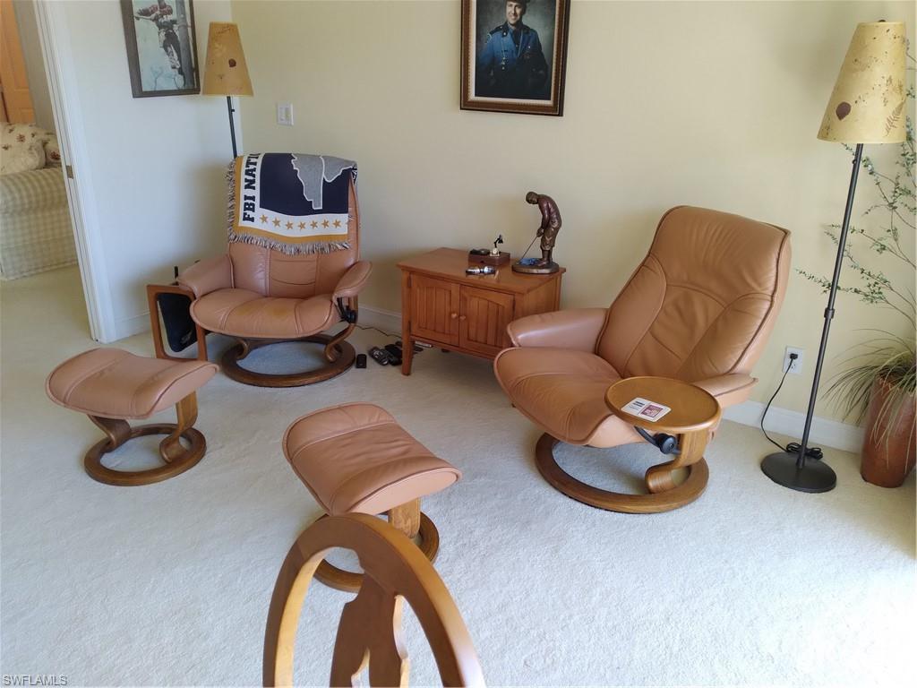 900 Diamond Circle, Unit 908 Naples, FL 34110 - Photo 22 of 22 a living room with furniture and a chair