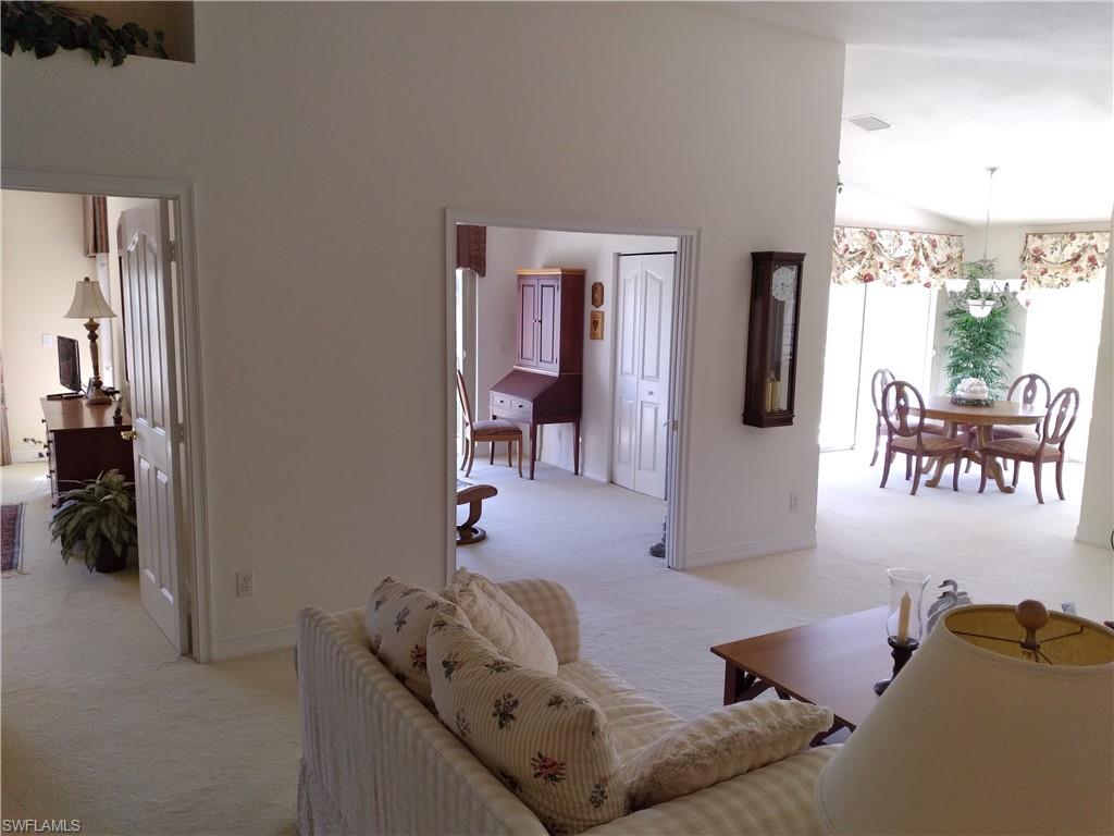 900 Diamond Circle, Unit 908 Naples, FL 34110 - Photo 3 of 22 a living room with furniture and a walk in closet