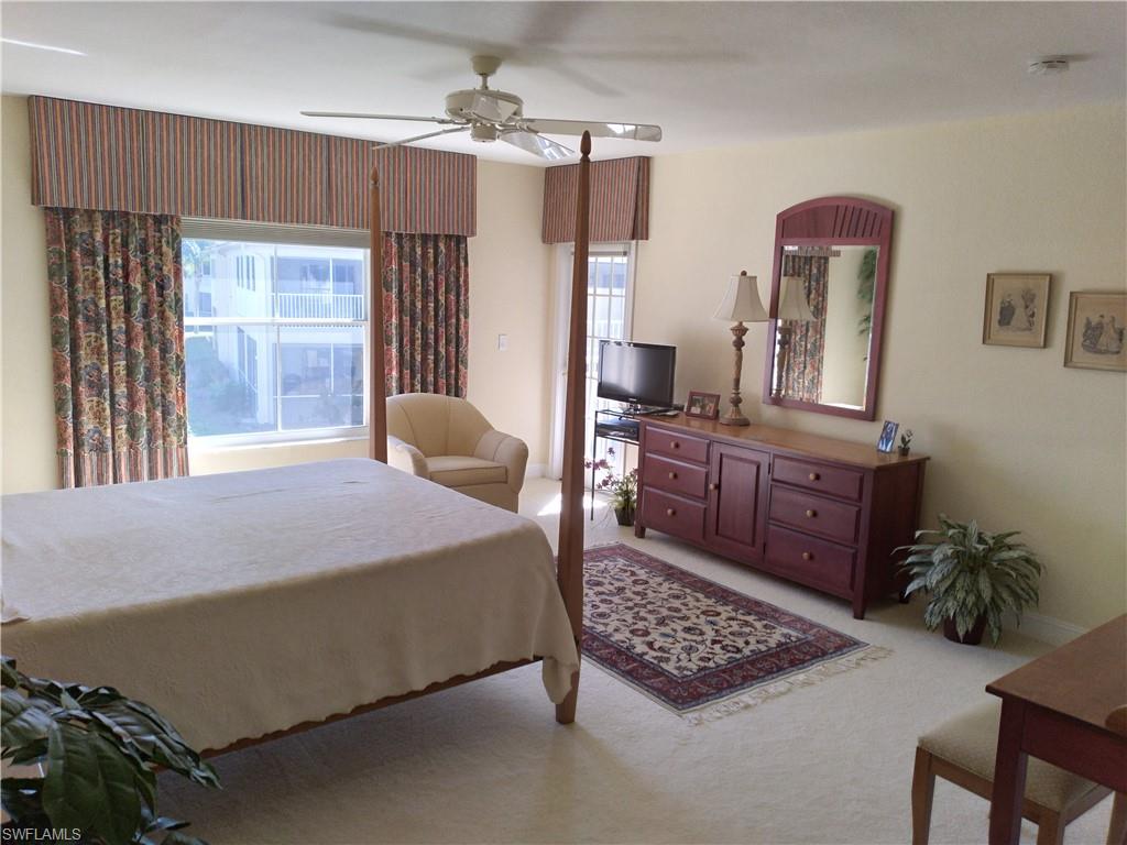 900 Diamond Circle, Unit 908 Naples, FL 34110 - Photo 5 of 22 a bedroom with a bed dresser and window