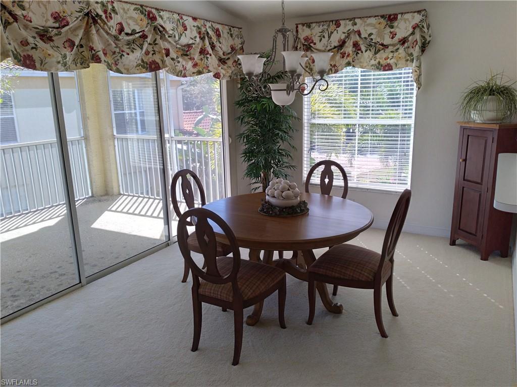 900 Diamond Circle, Unit 908 Naples, FL 34110 - Photo 6 of 22 a dining room with furniture and window