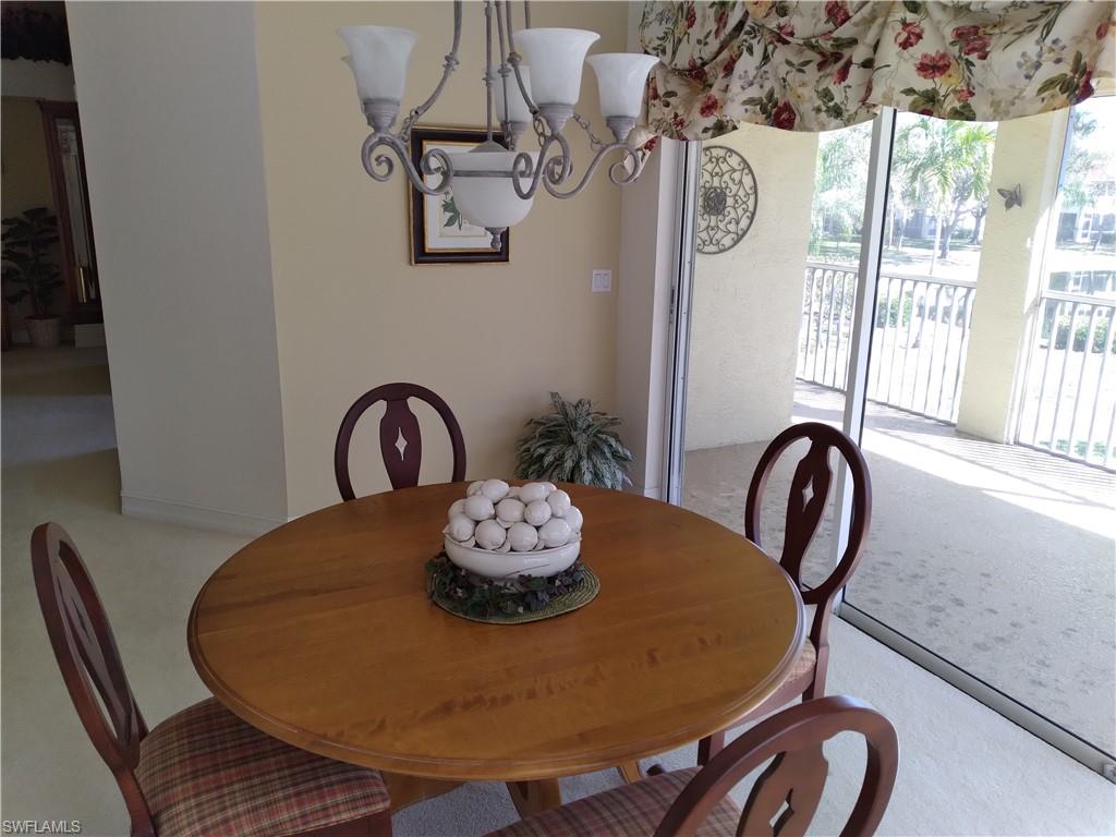 900 Diamond Circle, Unit 908 Naples, FL 34110 - Photo 7 of 22 a table with chairs and a table