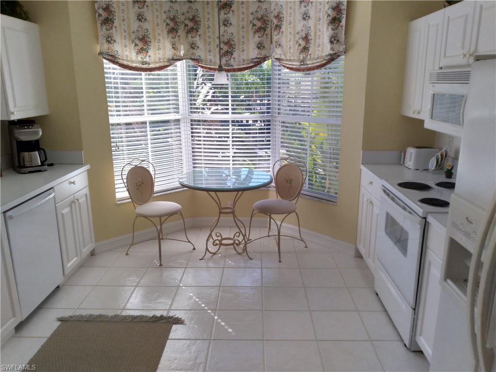 900 Diamond Circle, Unit 908 Naples, FL 34110 - Photo 9 of 22 a view of a kitchen with furniture and windows