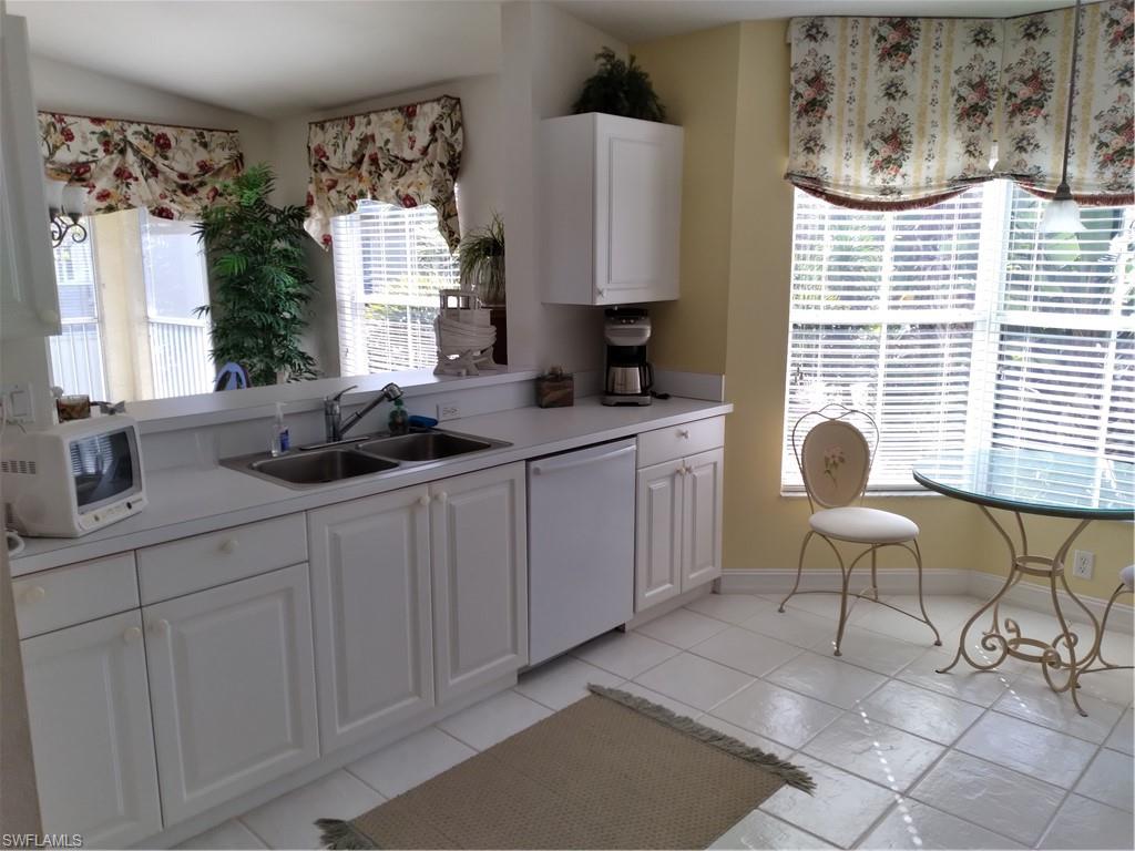 900 Diamond Circle, Unit 908 Naples, FL 34110 - Photo 10 of 22 a kitchen with a sink cabinets and window