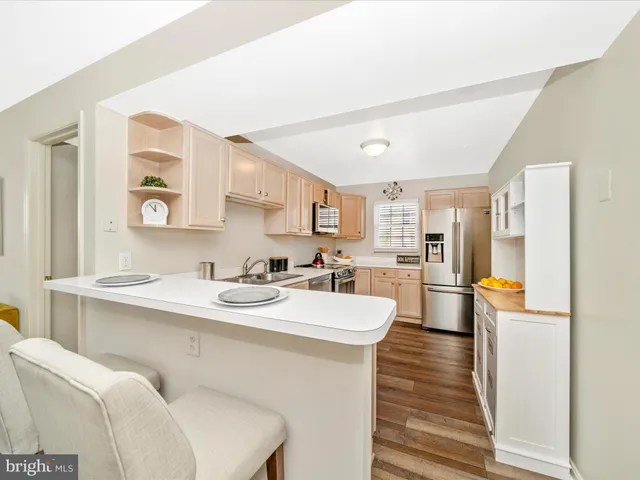 a kitchen with a sink stove and white cabinets