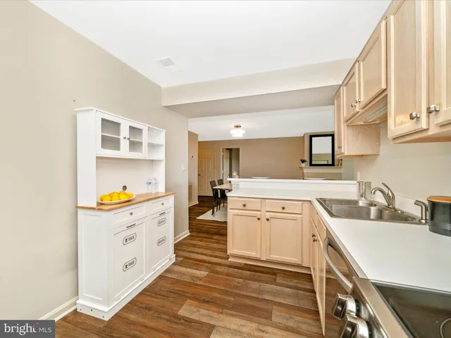 a kitchen with a sink stove and cabinets