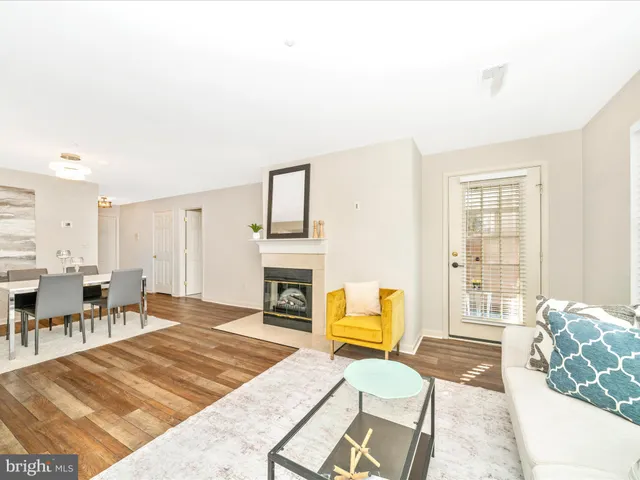 a living room with furniture a fireplace and a table