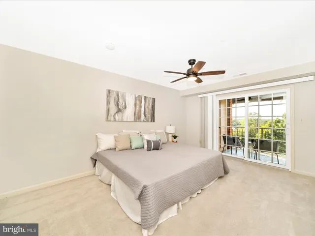 a bedroom with a bed and a large window with outer view