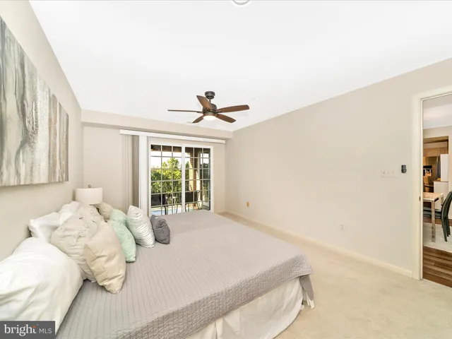 a bedroom with a bed and a large window