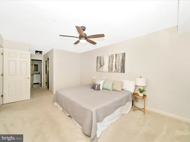 a living room with a bed and a chandelier
