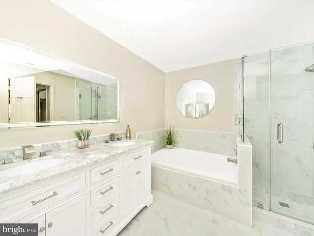 a bathroom with a bathtub and a shower