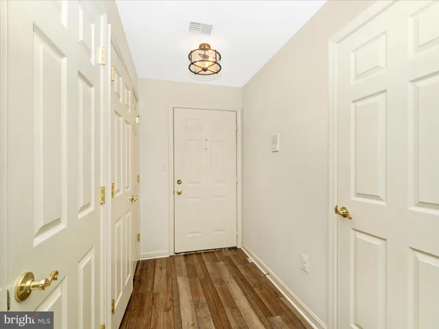 a view of a hallway with wooden floor